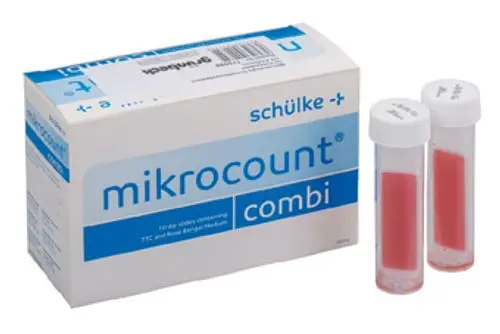 Zwei klare Probenröhrchen mit roter Flüssigkeit in einer Verpackung. Das Produkt gehört zur Marke Grünbeck und ist für mikrobiologische Tests konzipiert.